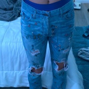 blue wash jeans with flower and vine design